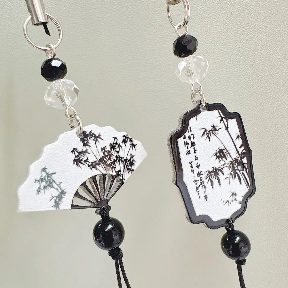 Handmade Chinese-style butterfly phone charm with calligraphy design. Elegant trinket strap and anti-lost cord for phones or bags.