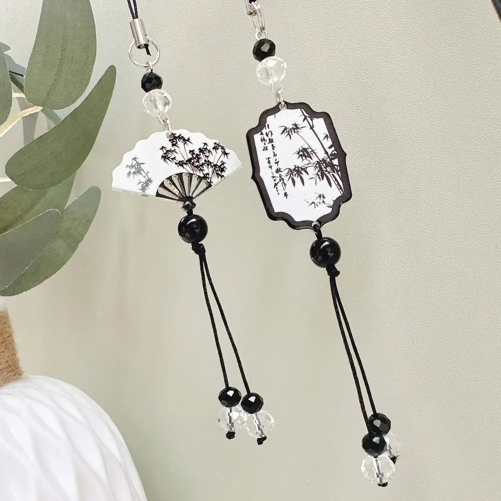 Handmade Chinese-style butterfly phone charm with calligraphy design. Elegant trinket strap and anti-lost cord for phones or bags.