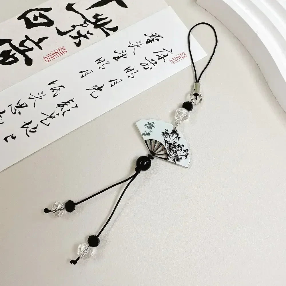 Handmade Chinese-style butterfly phone charm with calligraphy design. Elegant trinket strap and anti-lost cord for phones or bags.