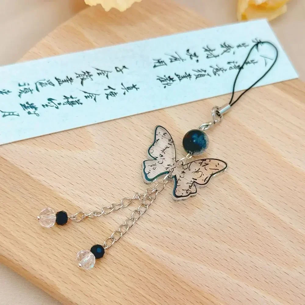 Handmade Chinese-style butterfly phone charm with calligraphy design. Elegant trinket strap and anti-lost cord for phones or bags.